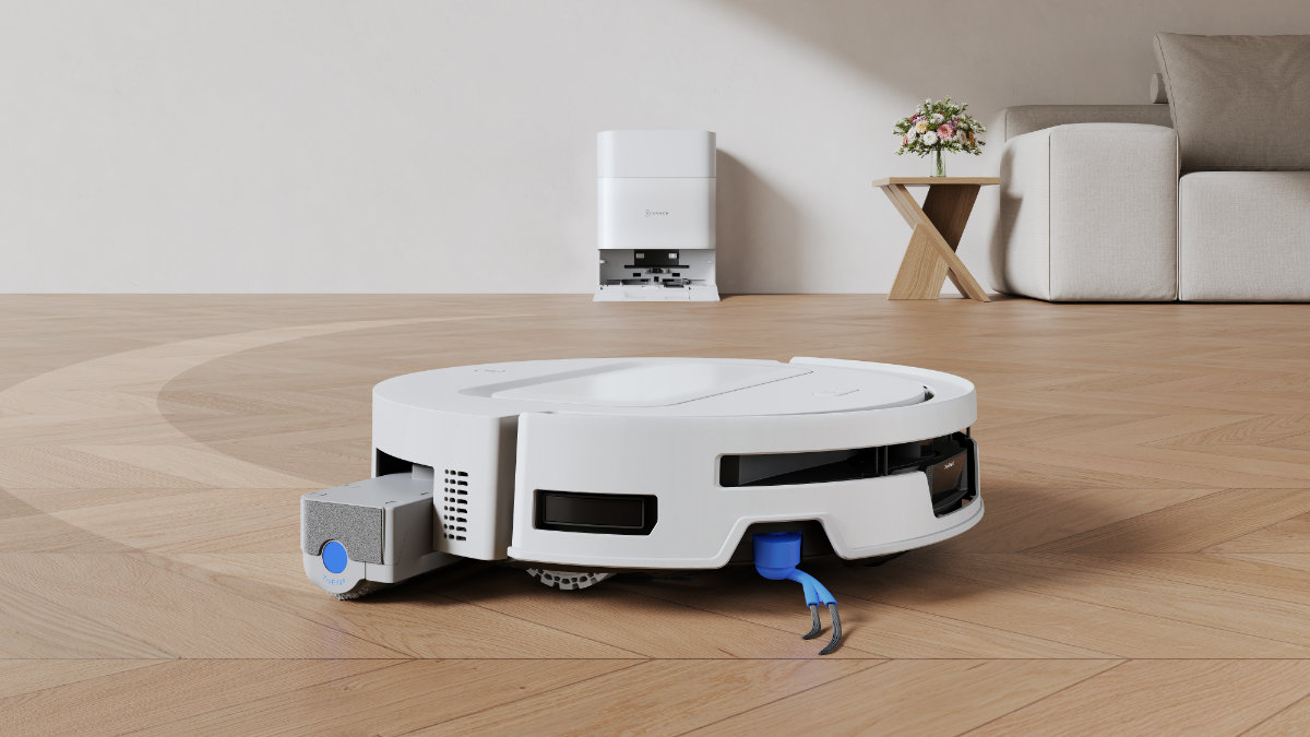 ECOVACS DEEBOT T90 MAX OMNI – robot odkurzająco-mopujący sprzątający podłogę, w tle stacja OMNI
