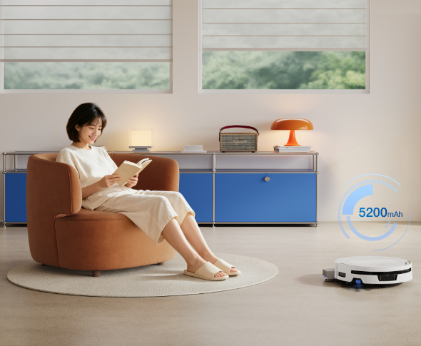 ECOVACS DEEBOT T90 MAX PRO OMNI Robot odkurzająco-mopujący pokazujący swoją pojemność, w tle kobieta na fotelu czytająca książkę relaksująca się.